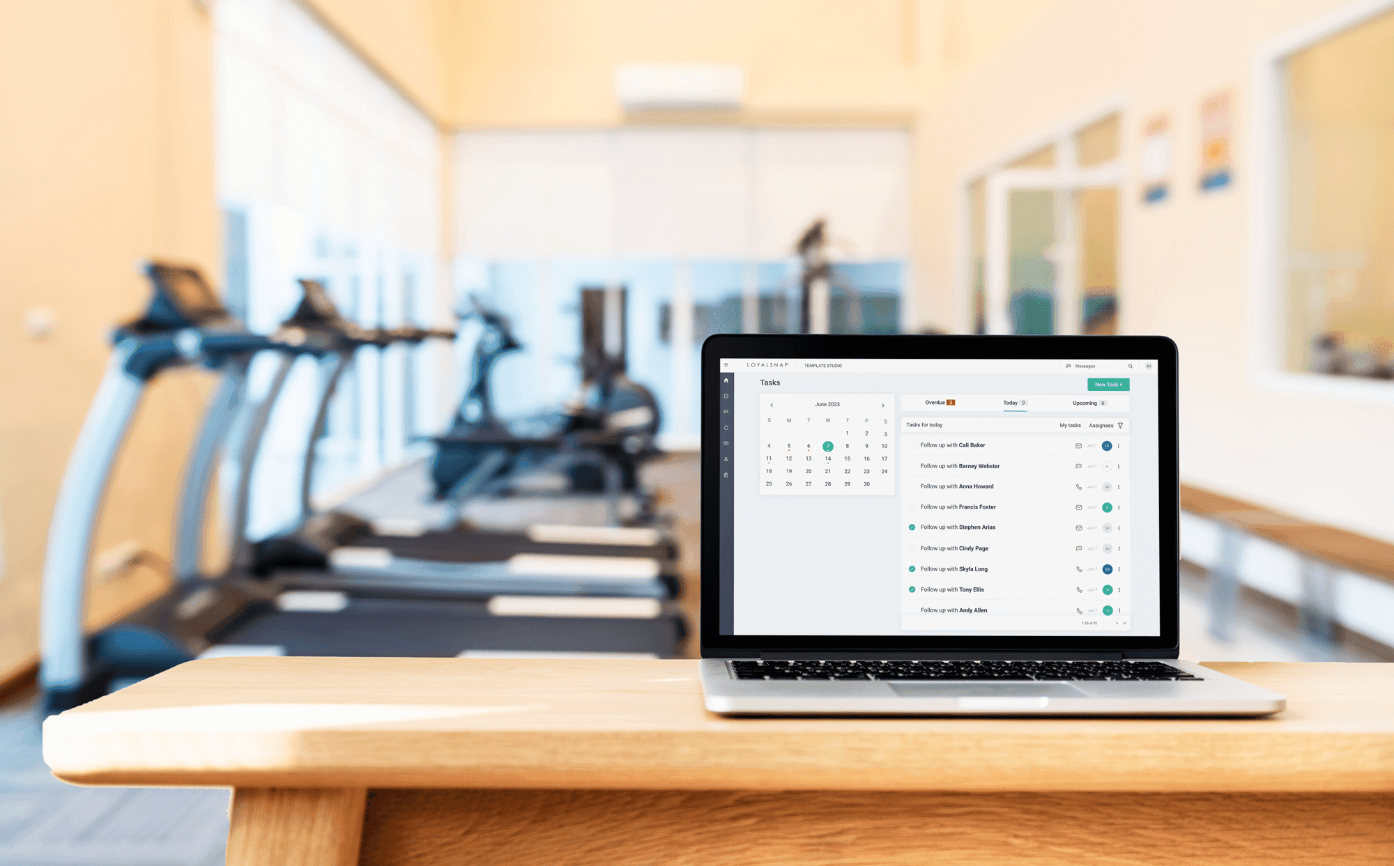 A laptop placed on a table in a gymnasium, ready for use.